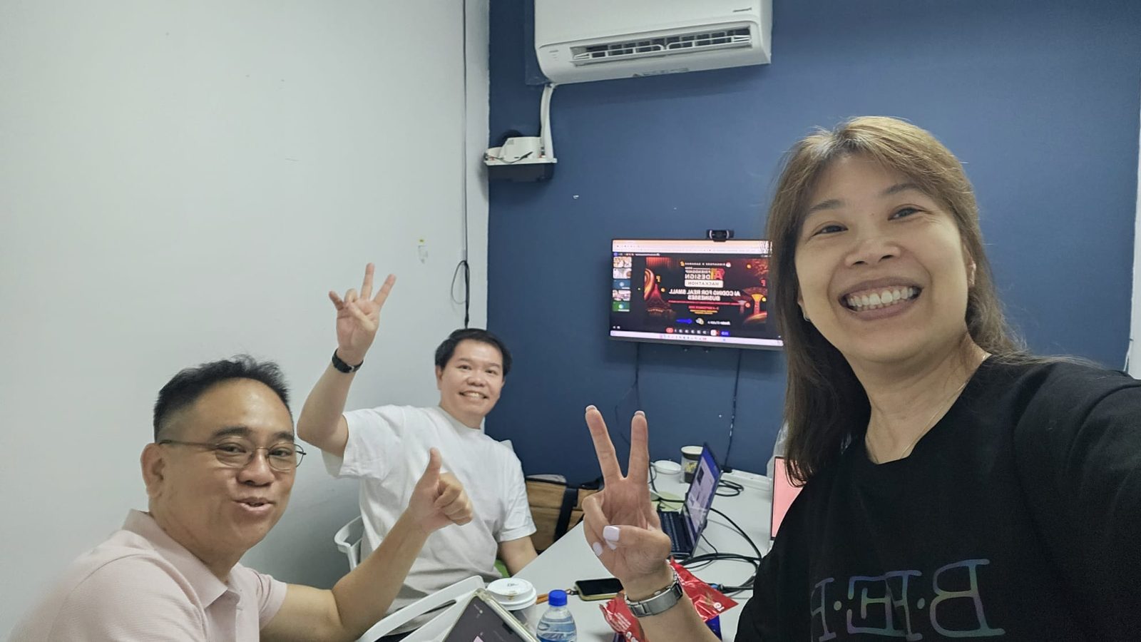 The three person Singapore team on a video call with the Kuching venue during the hackathon
