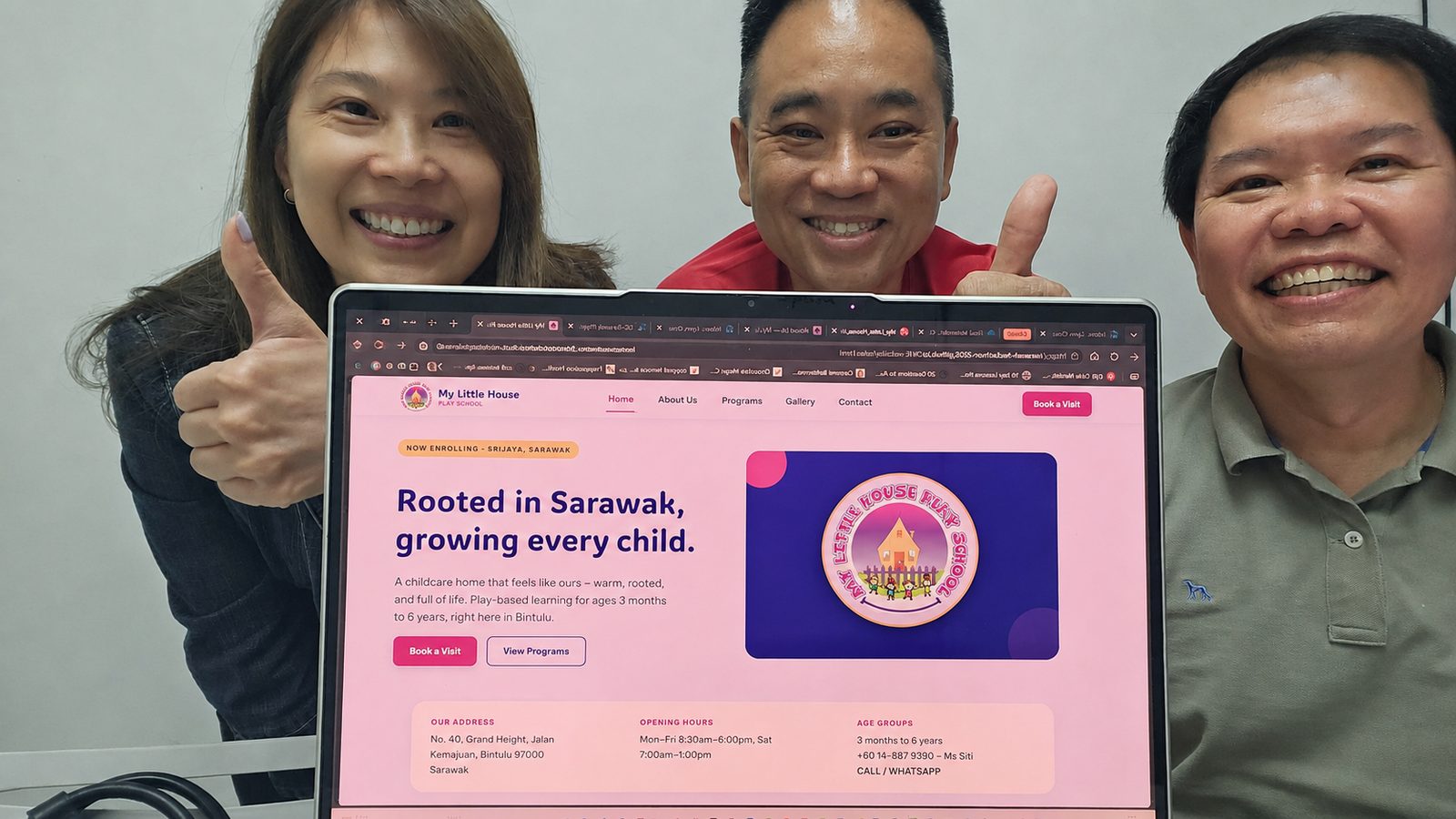 Damien Goh, on the right, with teammates Francis Lee and Lynn Choa holding a laptop that shows the finished My Little House Play School website