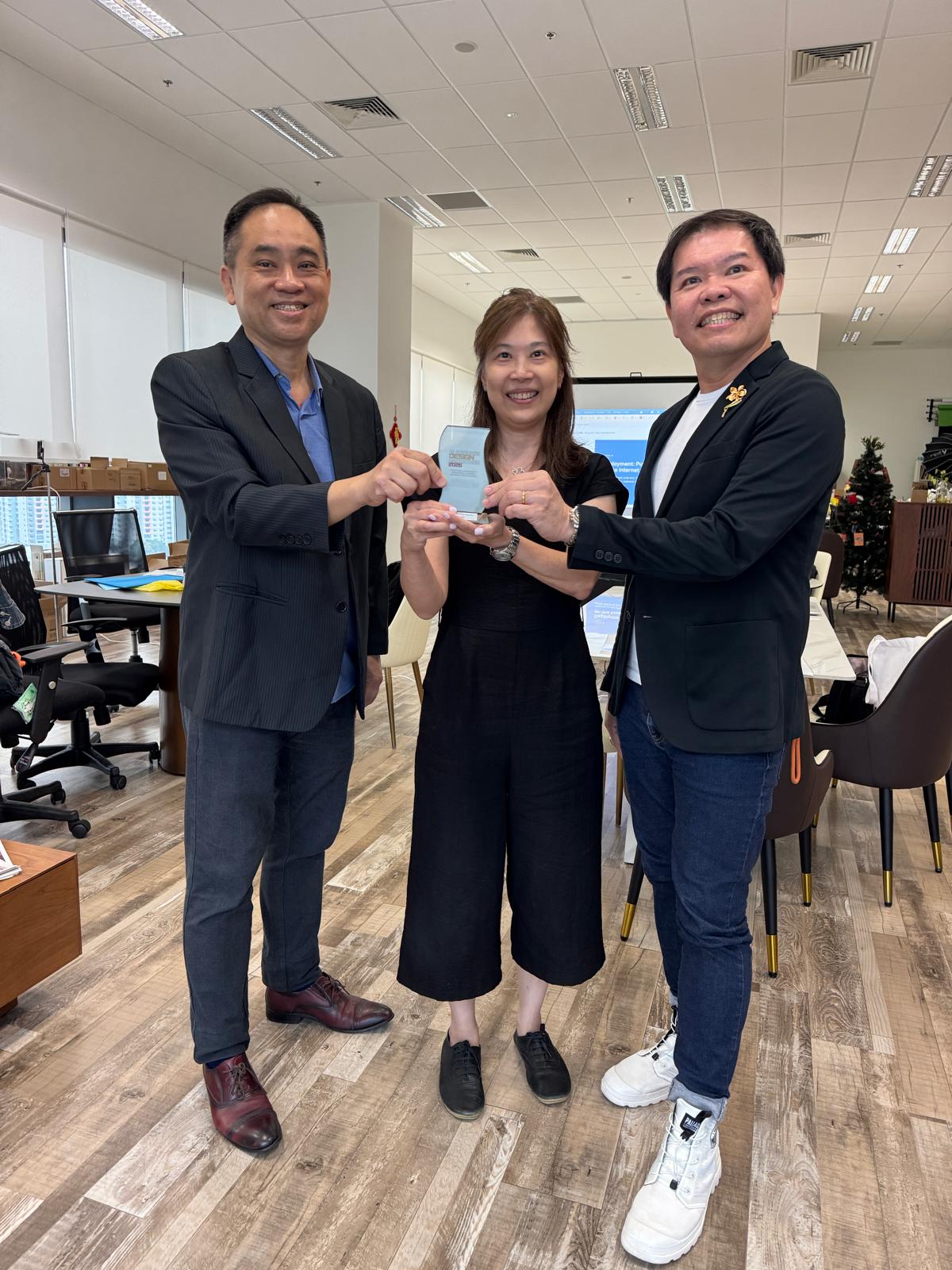 Francis Lee, Lynn Choa and Damien Goh together holding the Second Runner Up trophy in their Singapore office